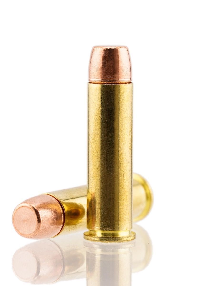 Two bullets are sitting on a white surface.