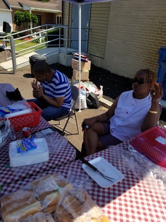 A man and a woman are sitting at a table eating food