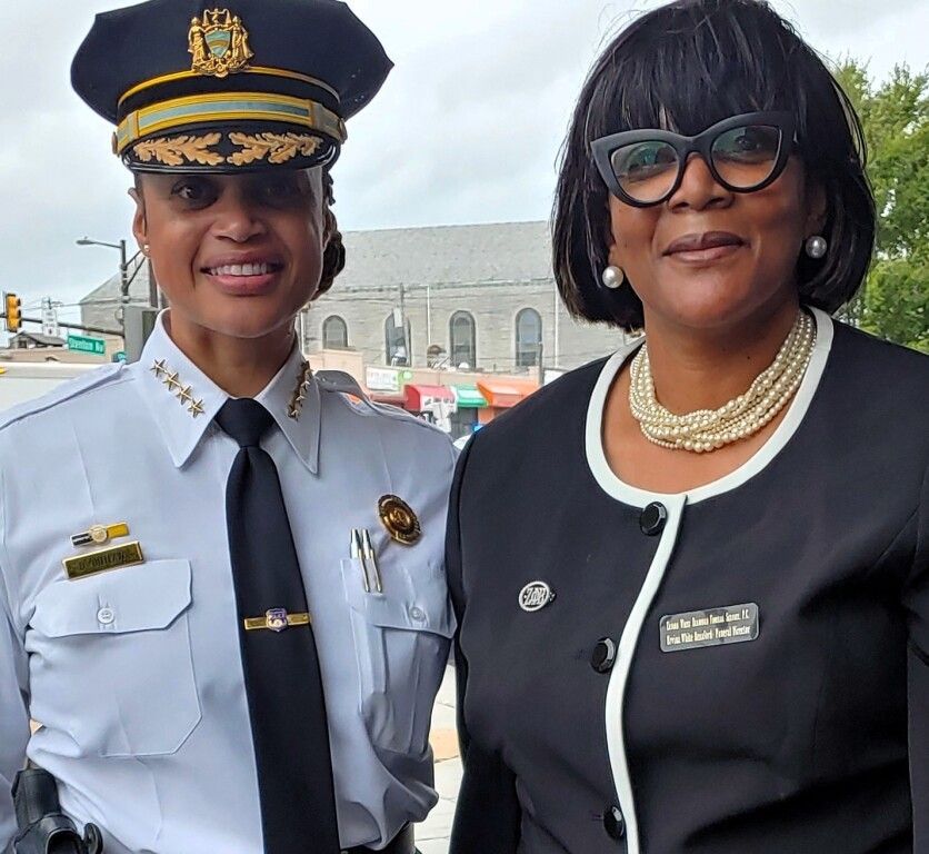 A police officer and a woman are posing for a picture