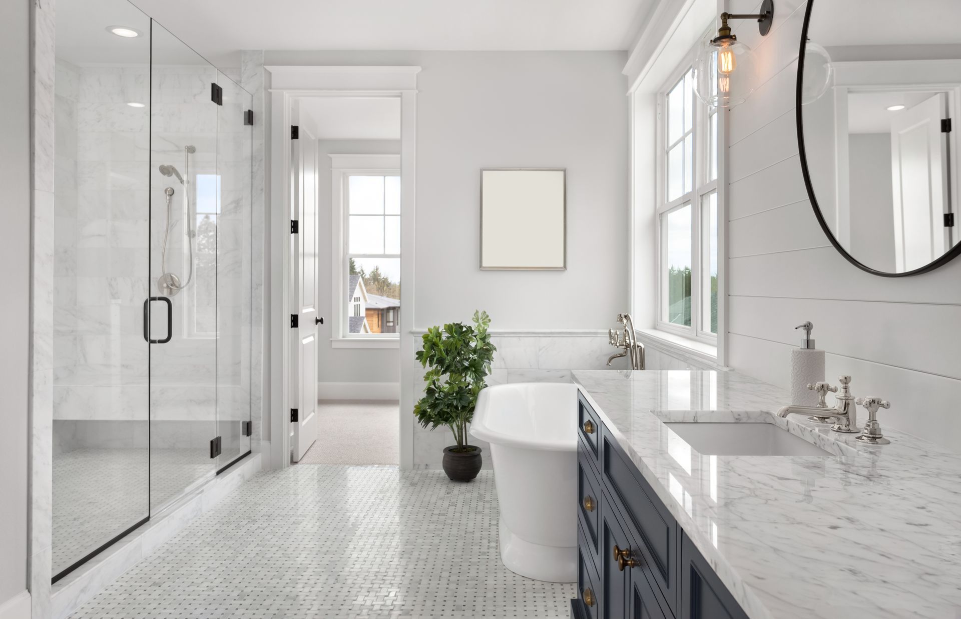A bathroom with a bathtub , sink , shower and mirror.