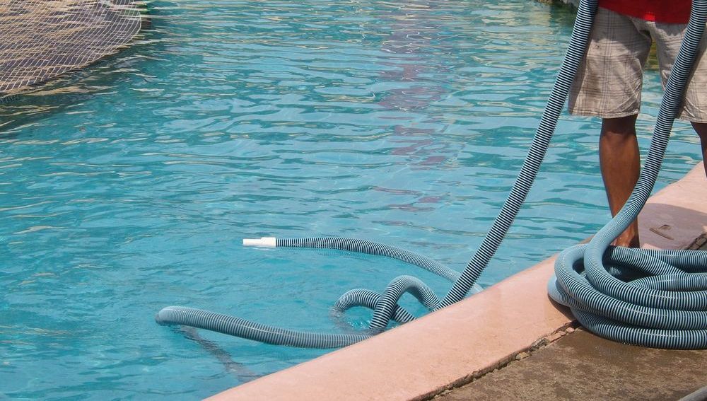 Person cleaning the pool