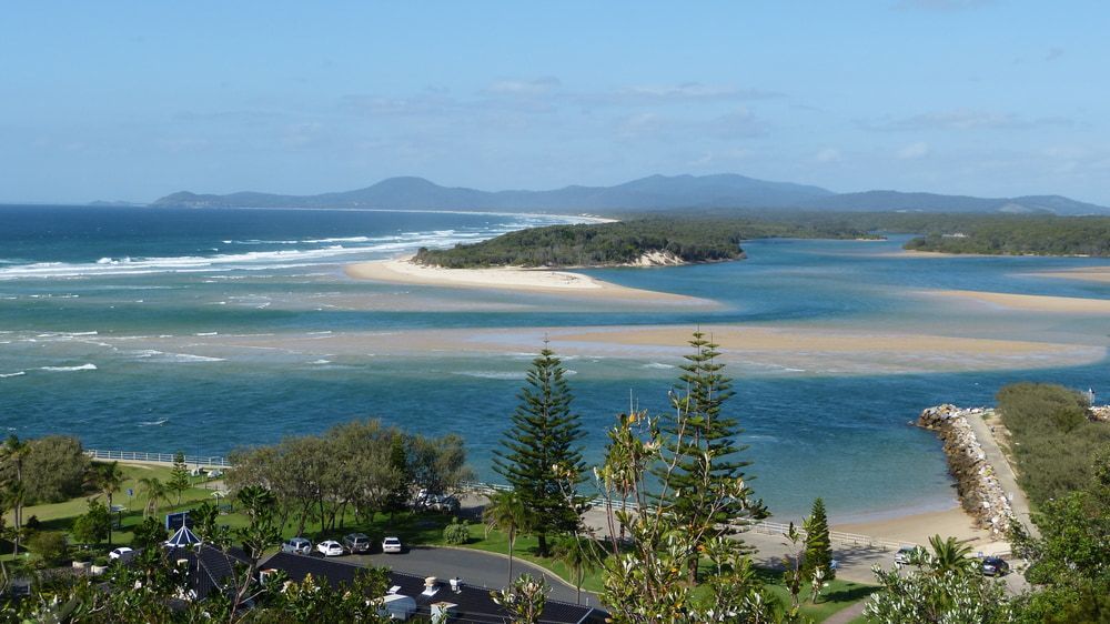 A View Of A Body Of Water With Mountains In The Background — Holiday Coast Pools & Water In Nambucca Heads, NSW