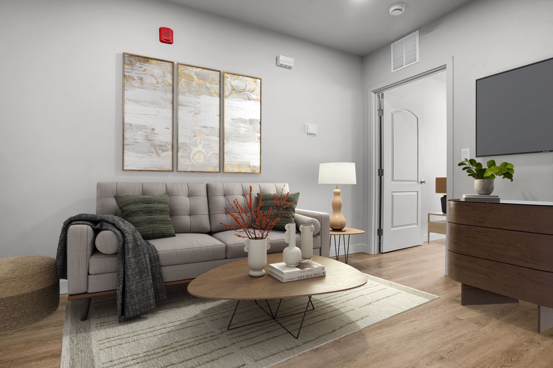 A living room with a couch , coffee table , and television.