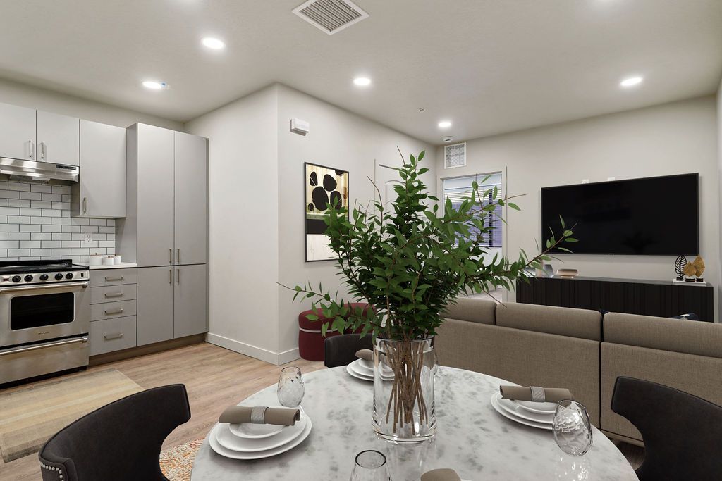 An artist 's impression of a living room with a dining table and chairs.