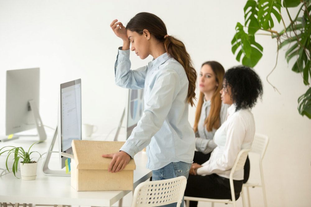 Office Setting, Stressed Expression, Holding Head — Living Well Chiropractic Coffs Harbour in Coffs Harbour, NSW