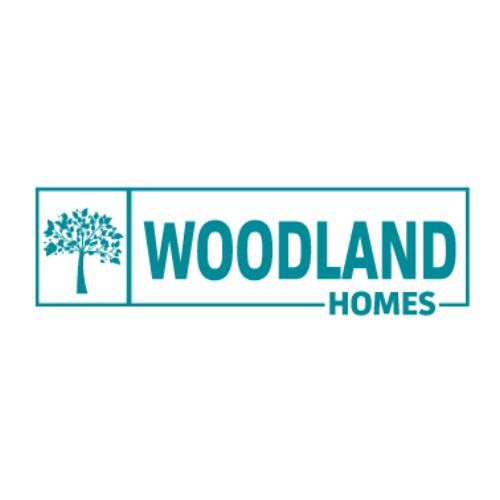 the logo for woodland homes has a tree on it .