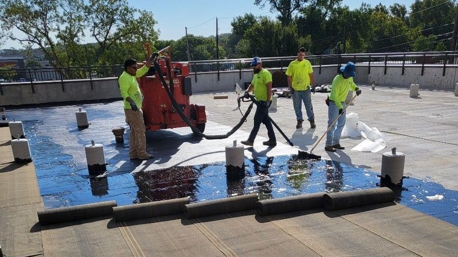 Men waterproofing commercial roof
