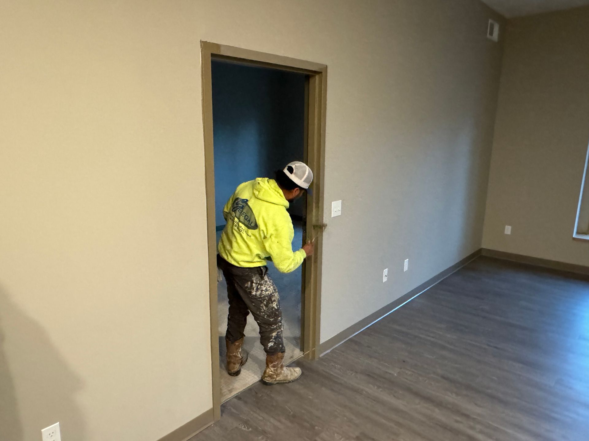 a man is painting a door in a room .