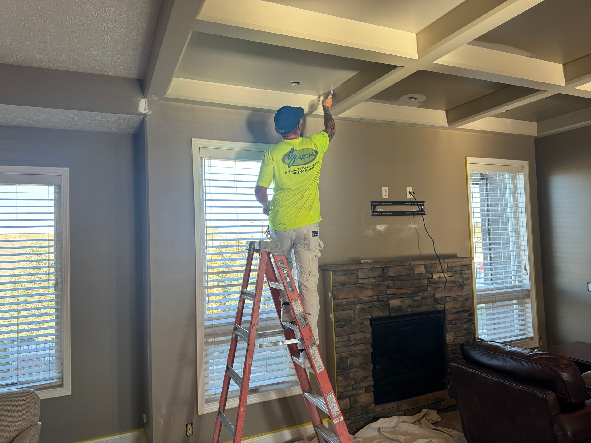 Man painting the interior of new home