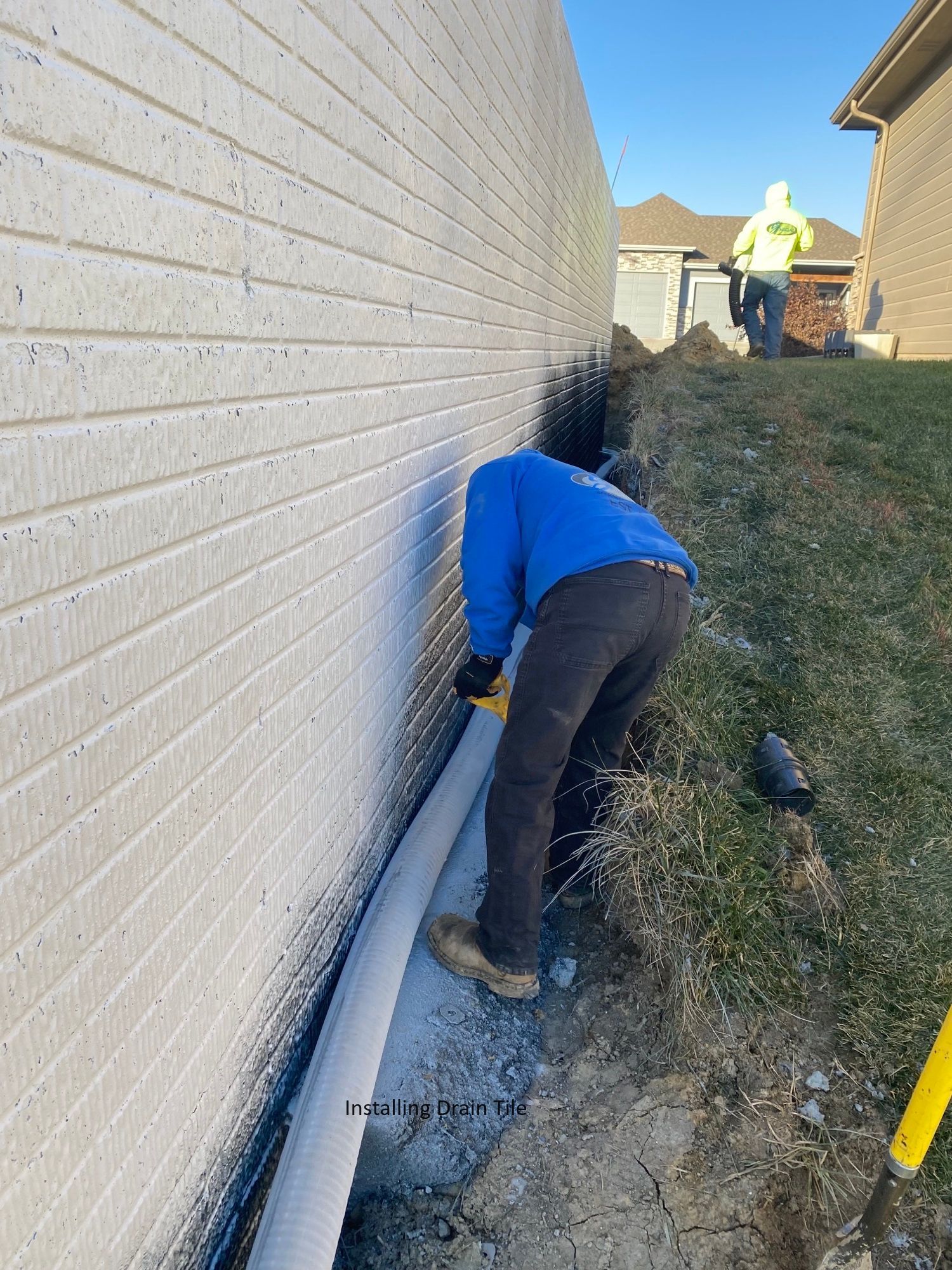 a man is working on the side of a house .