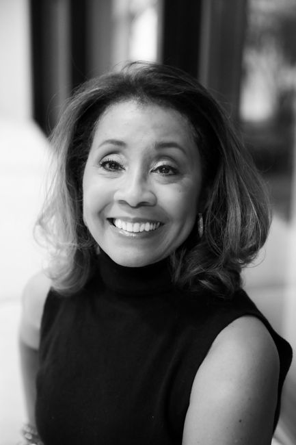 Diane Davis with dark hair wearing a black turtleneck top.