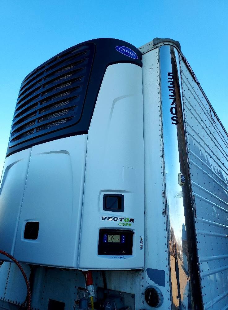 A refrigerator on the side of a semi truck
