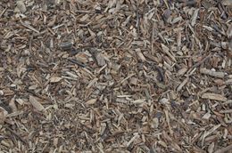 Close-up of brown wood chips scattered across the ground