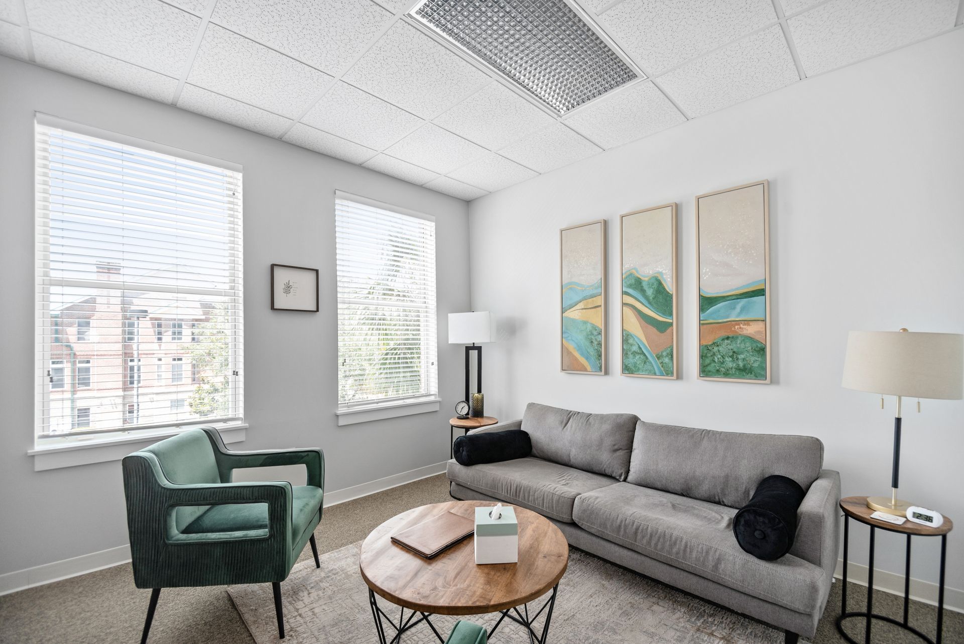 A living room with a couch , chairs , and a coffee table.