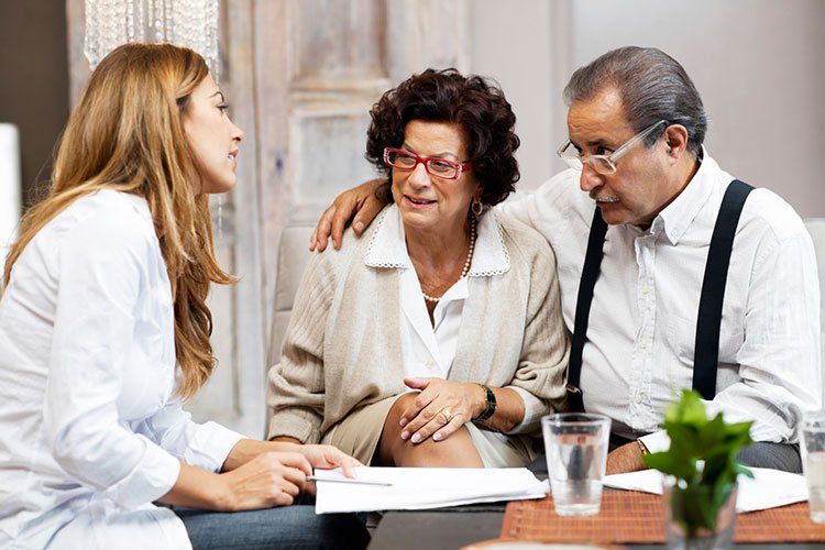 older couple talks to a younger woman