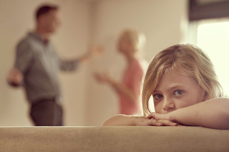 distressed young girl's parents argue in background
