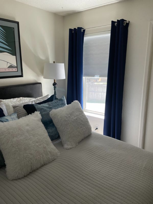 A bedroom with a bed , lamp , curtains and a window. Love is Blinds Arizona (844) 936-2446