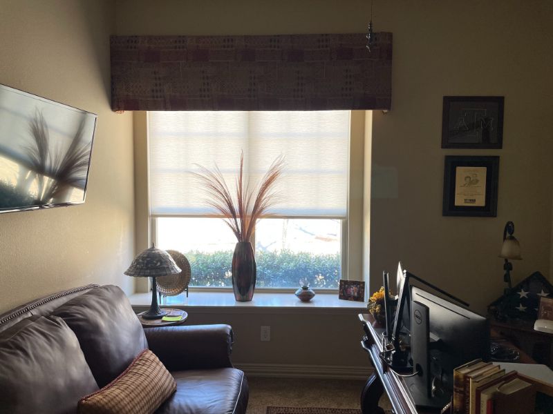 A living room with a couch a desk and a window Love is Blinds Arizona (844) 936-2446