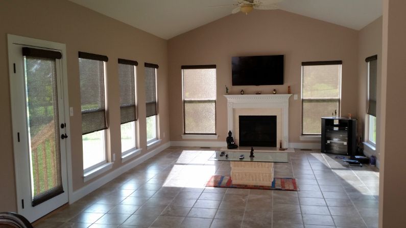 A living room with a fireplace and a flat screen tv