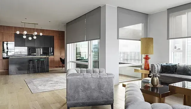 A living room with a couch , chair , table and a kitchen. Love is Blinds Arizona (844) 936-2446