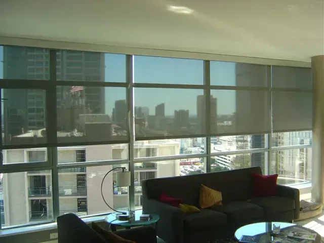 A living room with a couch and a view of the city Love is Blinds Michigan