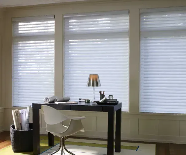 A desk and chair in a room with white blinds Love is Blinds Arizona (844) 936-2446