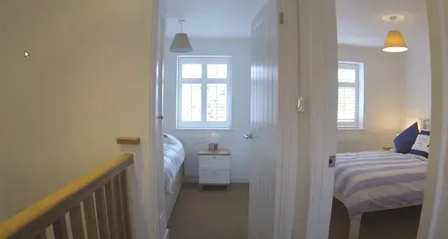 A bedroom with a bed and a nightstand in it Love is Blinds Arizona (844) 936-2446