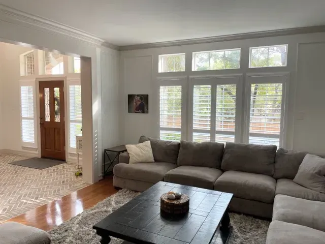 A living room with a couch and a coffee table Love is Blinds Arizona (844) 936-2446
