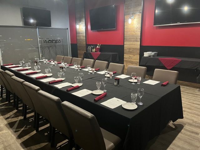 Set dining table in a modern red-and-black restaurant room