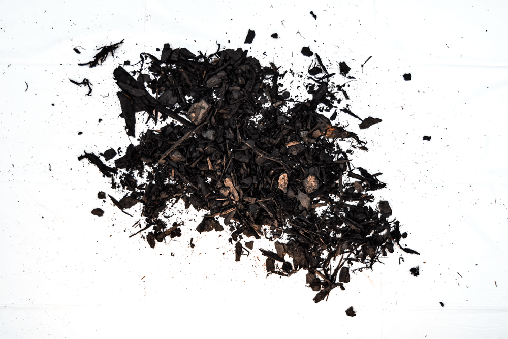 Pile of loose black tea leaves on a white background