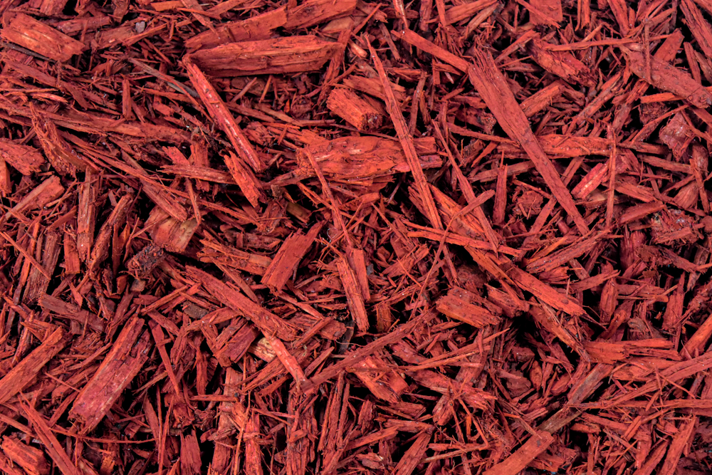 Red wood mulch with shredded bark pieces.