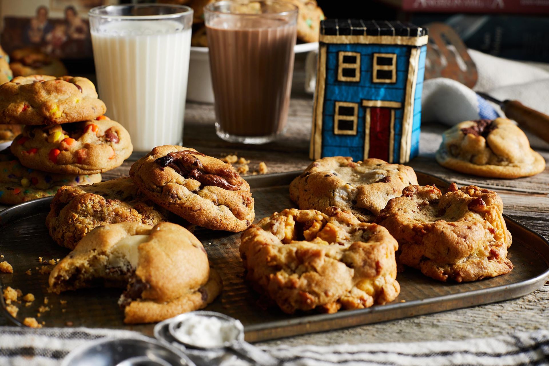 A tray of cookies and a glass of milk on a table.