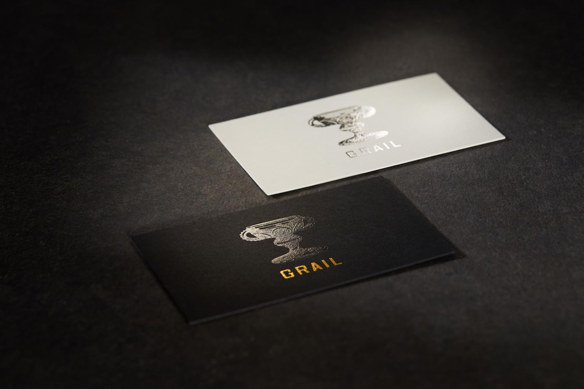 A black and white business card with the word grail on it