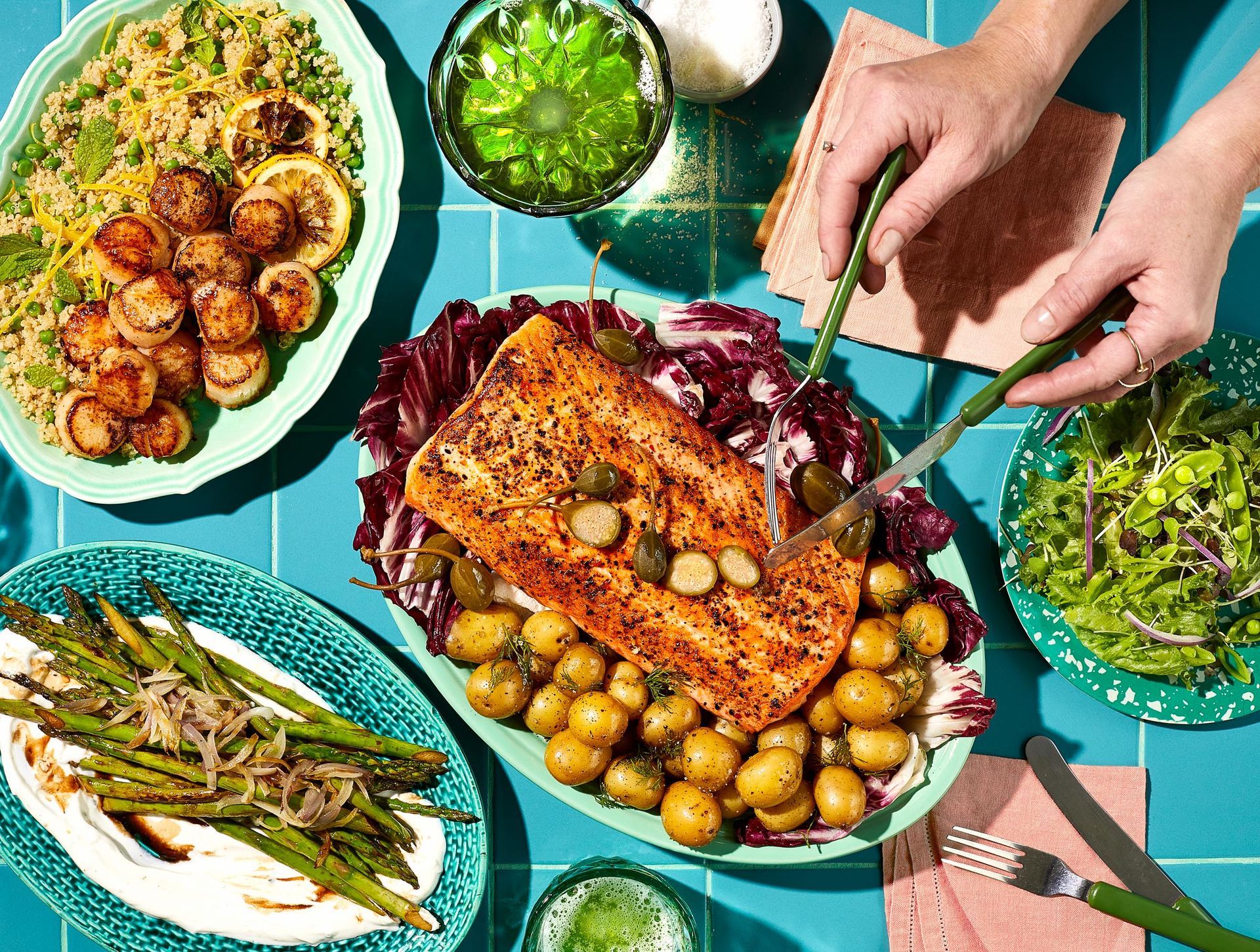 A person is cutting a piece of salmon on a plate.