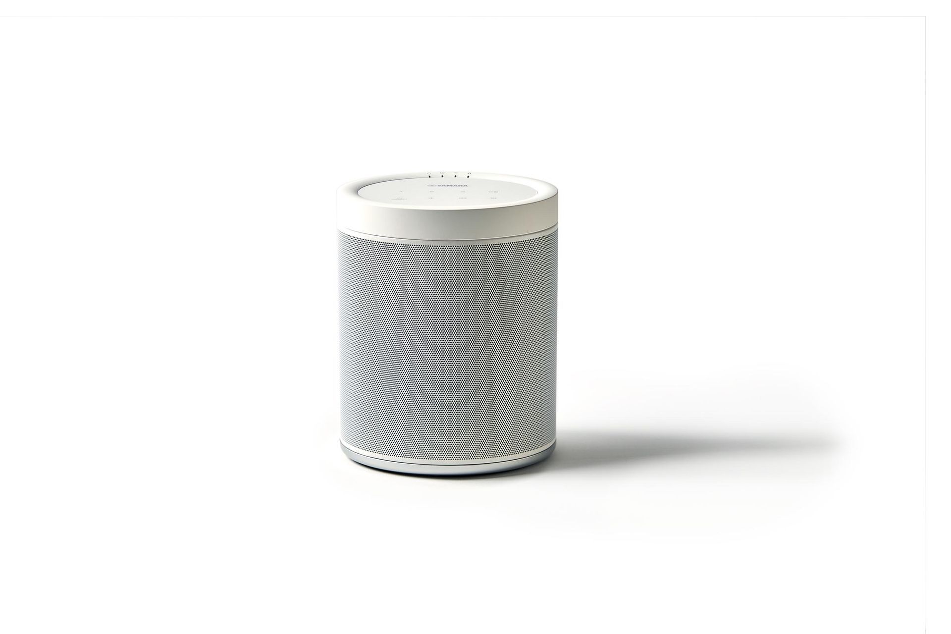 A white cylinder with a black and white pattern on it is sitting on a white surface.