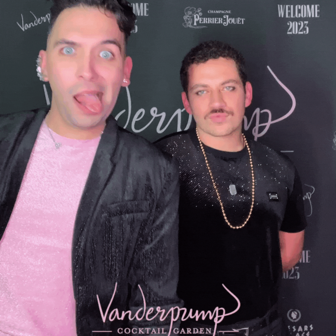 Two men standing in front of a sign that says vanderpump