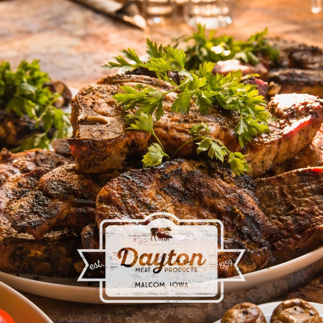 A plate of grilled meat and vegetables is on a table.