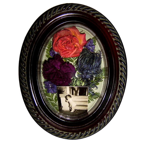 Oval black-framed memorial collage with flowers and a small black-and-white photo