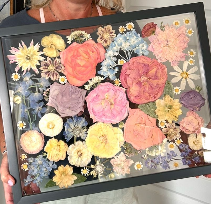 pastel pressed flowers in a black frame