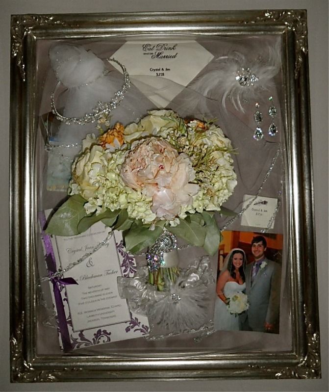 Framed wedding bouquet keepsake with flowers, invitation, jewelry, and a small wedding photo