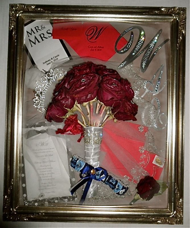 Framed bridal shadow box with red roses, silver shoes, garter, and a “Mr & Mrs” card