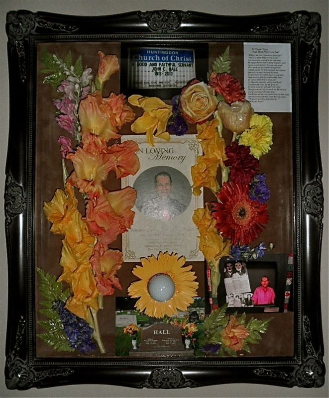 Framed memorial collage with flower garlands, portraits, and a centered circular photo.