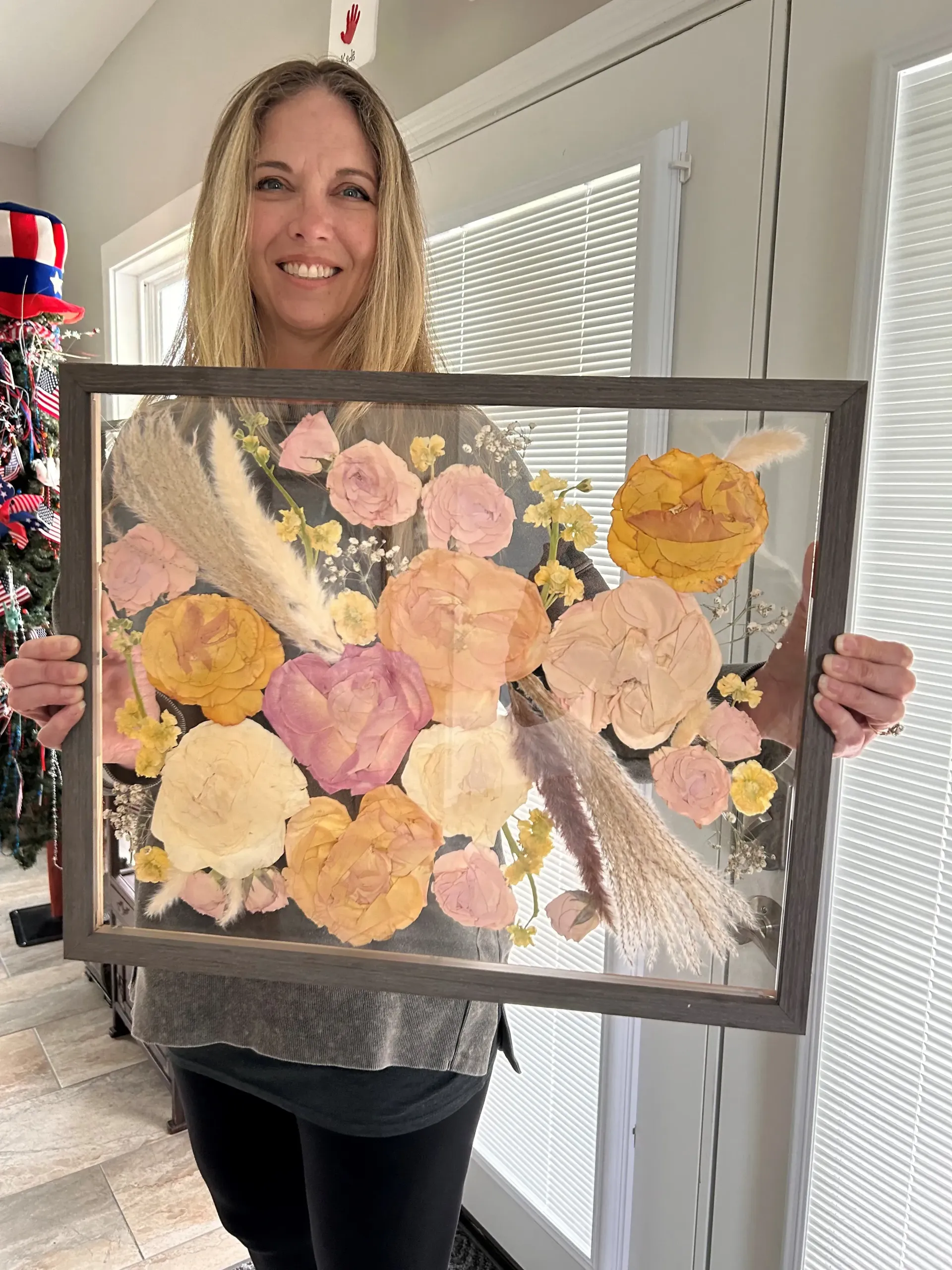 pink and yellow pressed flowers in black frame