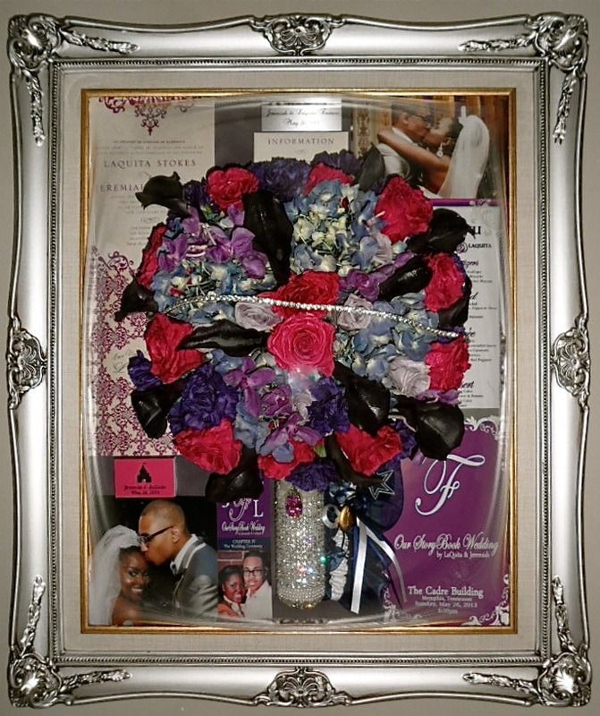 Framed floral collage with colorful bouquet, photos, and purple commemorative card on a shelf