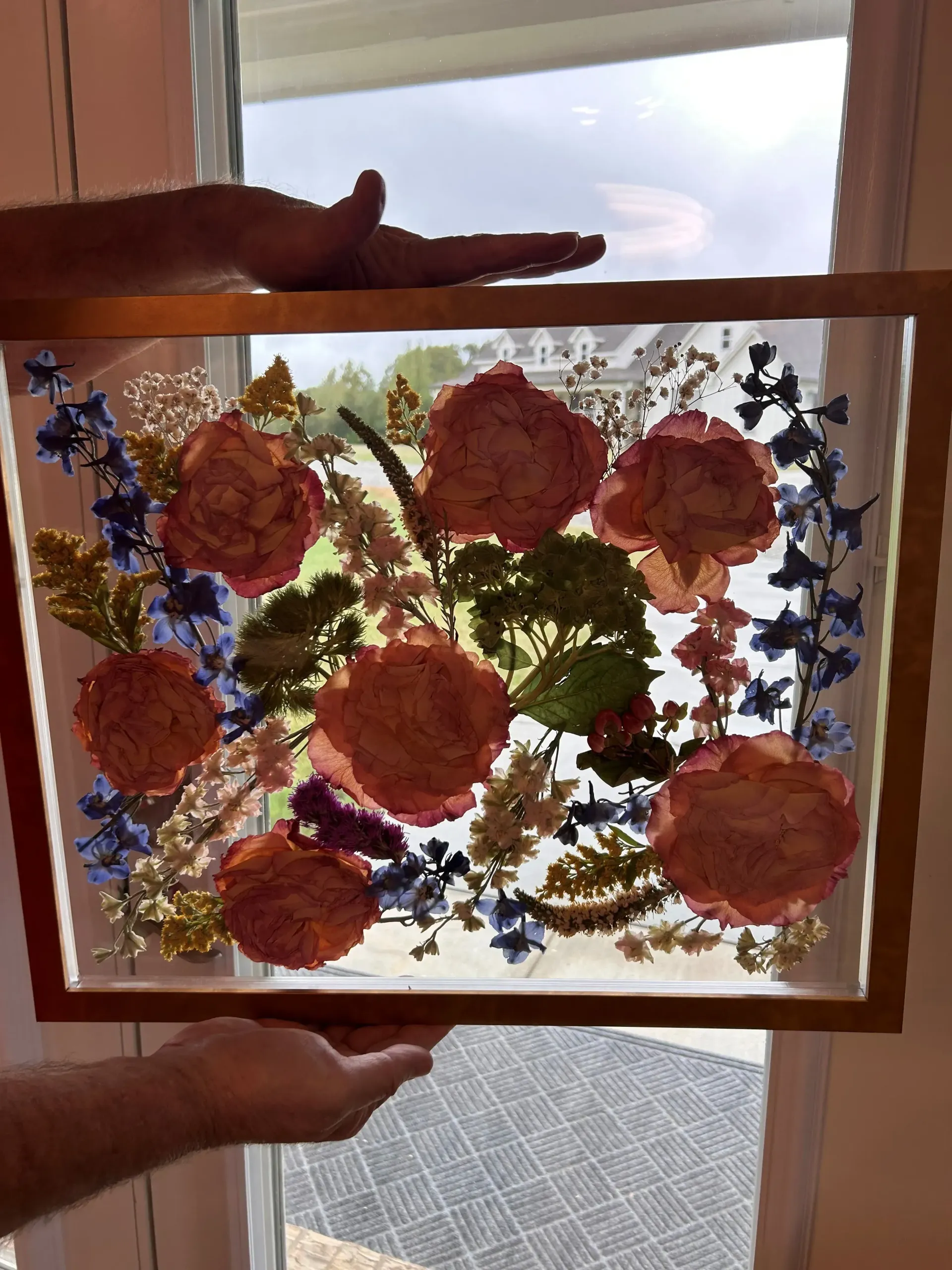 pink and blue pressed flowers in wooden frame
