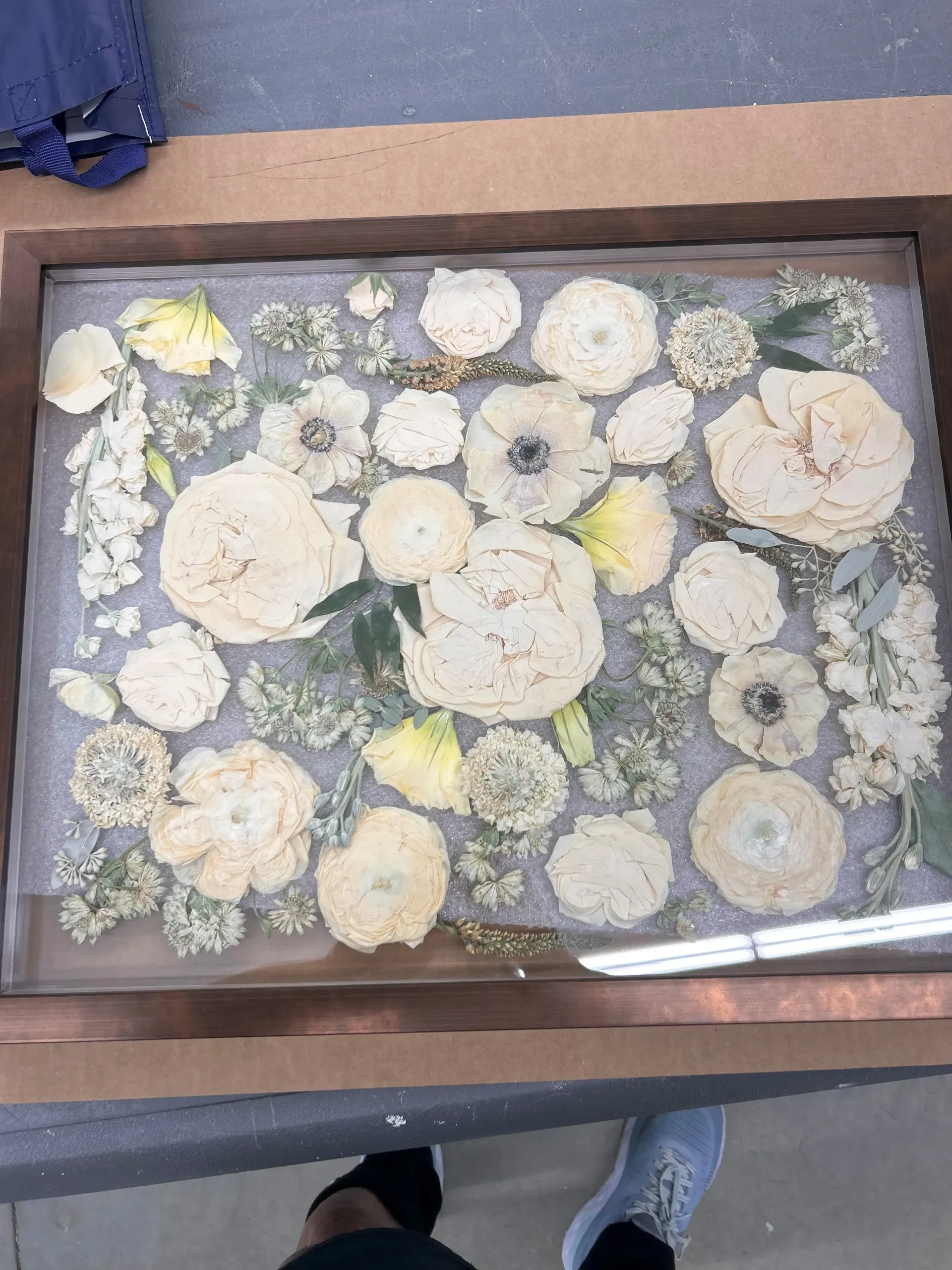 white pressed flowers in wooden frame