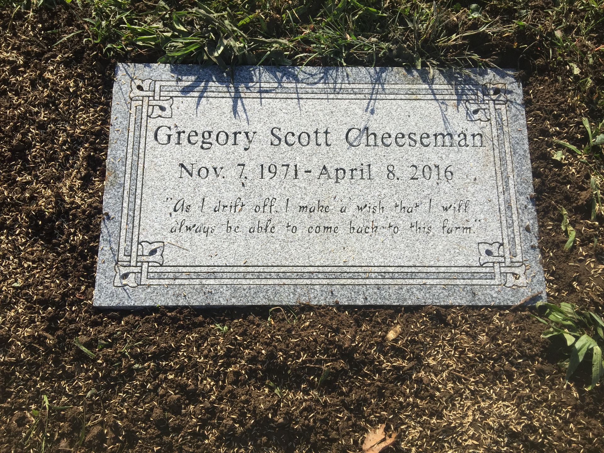 Flat gravestone in mulch with engraved name and dates, Gregory Scott Ochelsen, Nov. 3, 1917–Apr. 8, 2016.