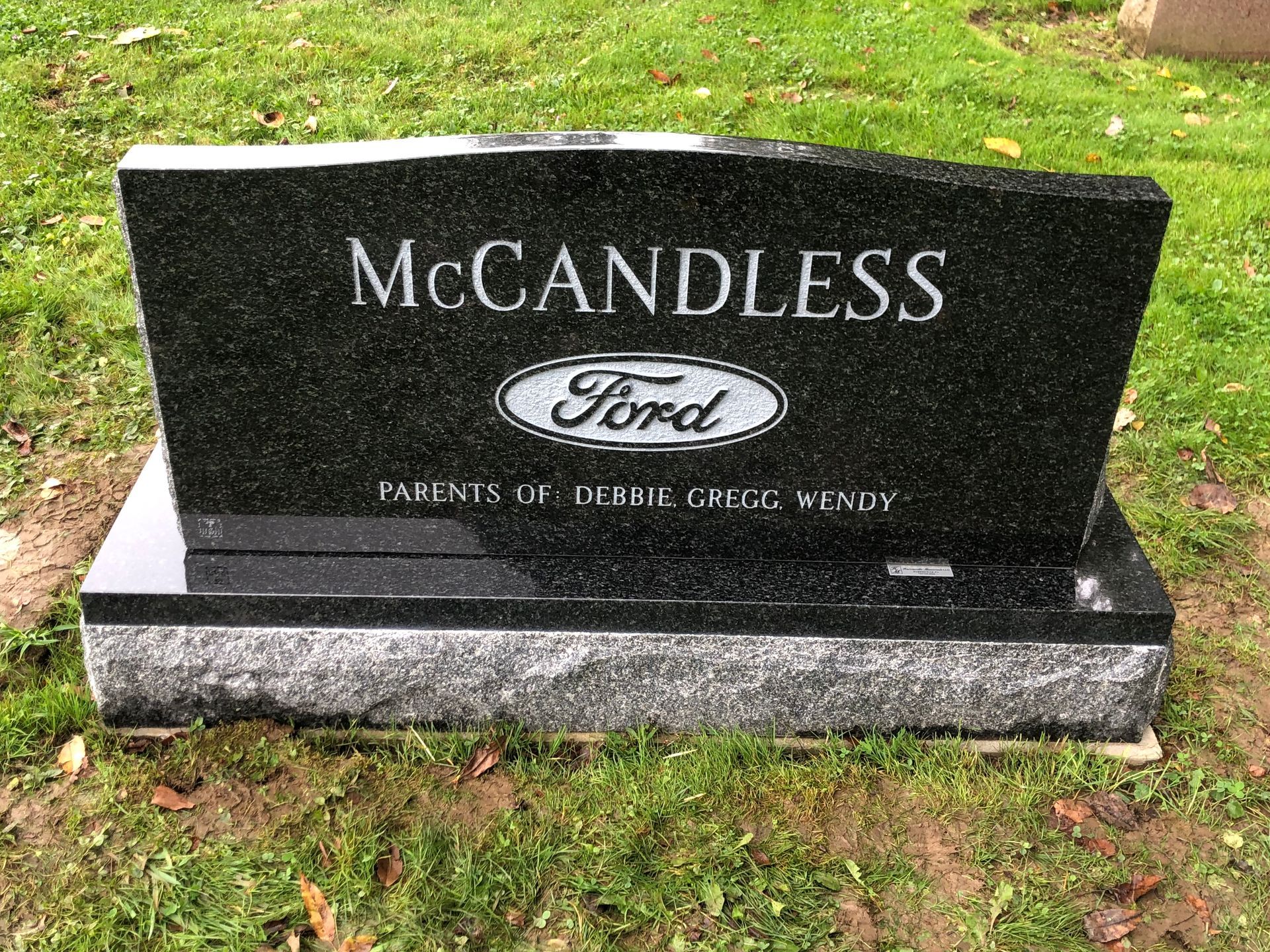 McCandless Ford black granite gravestone on a grassy lawn