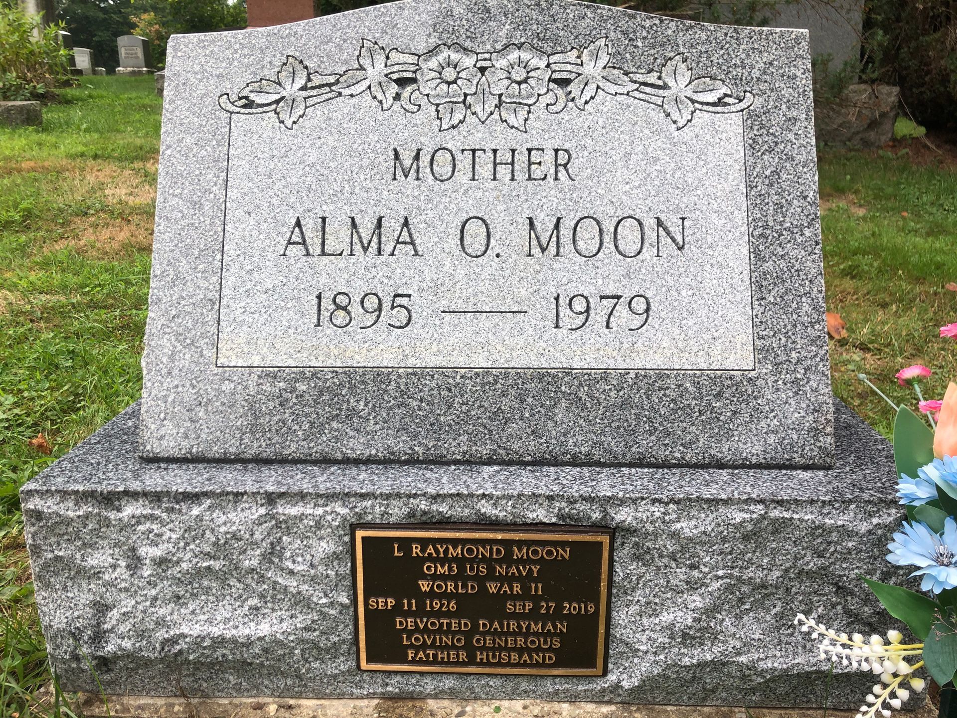 Gray granite gravestone in a cemetery reading “Mother Alma O. Moon, 1895–1979.”