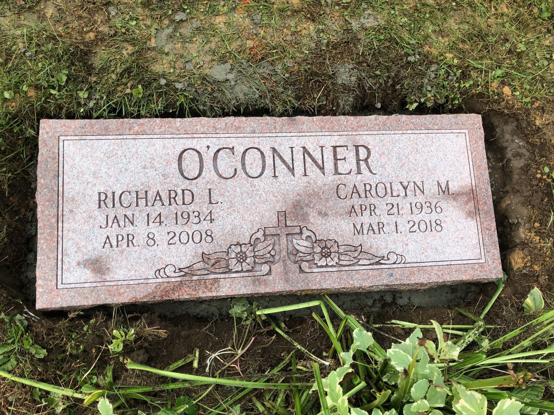 O’CONNER gravestone with two engraved names, surrounded by grass and moss